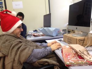 Roberto working with his christmas hat and blanket.