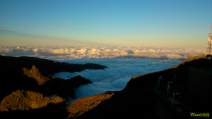 Sunset in pico do areeiro with the clouds covering the mountains.